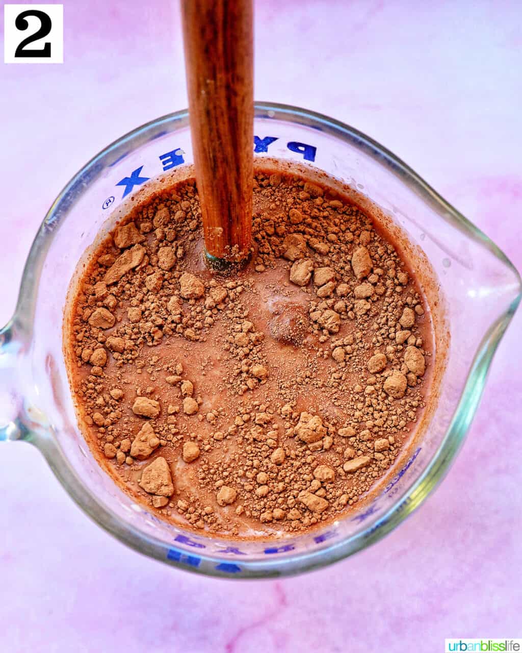 mixing in chocolate in a measuring cup.