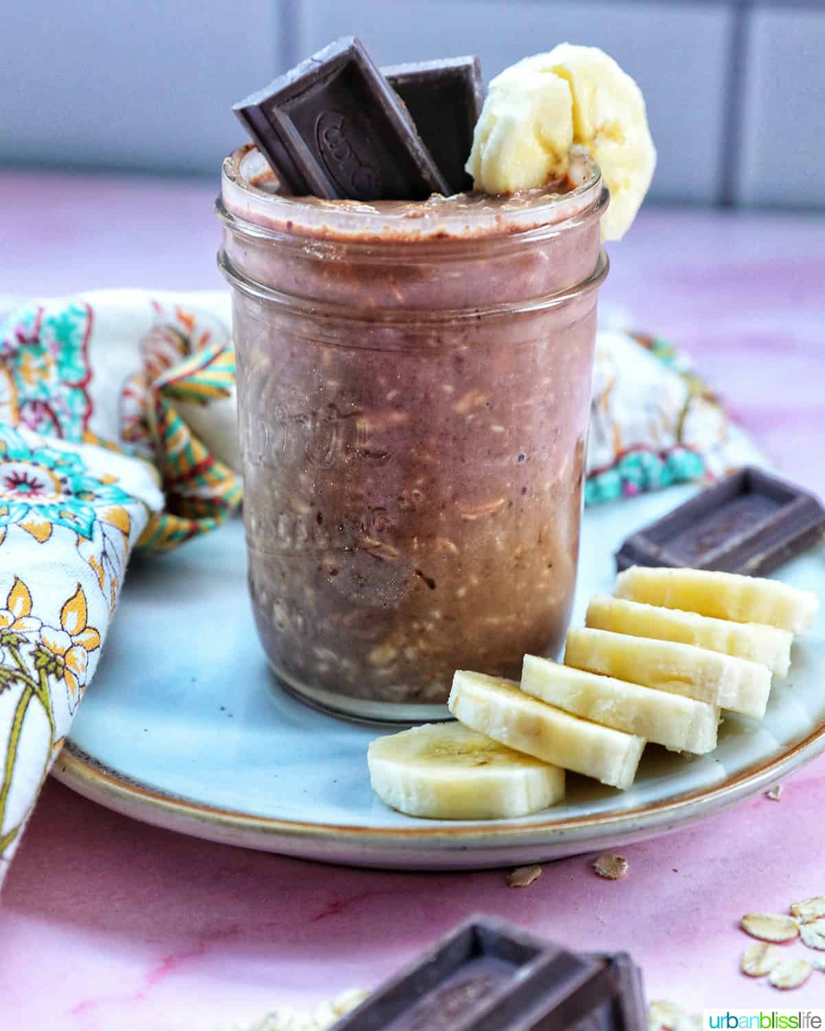 chocolate protein overnight oats topped with banana slices and chocolate pieces.