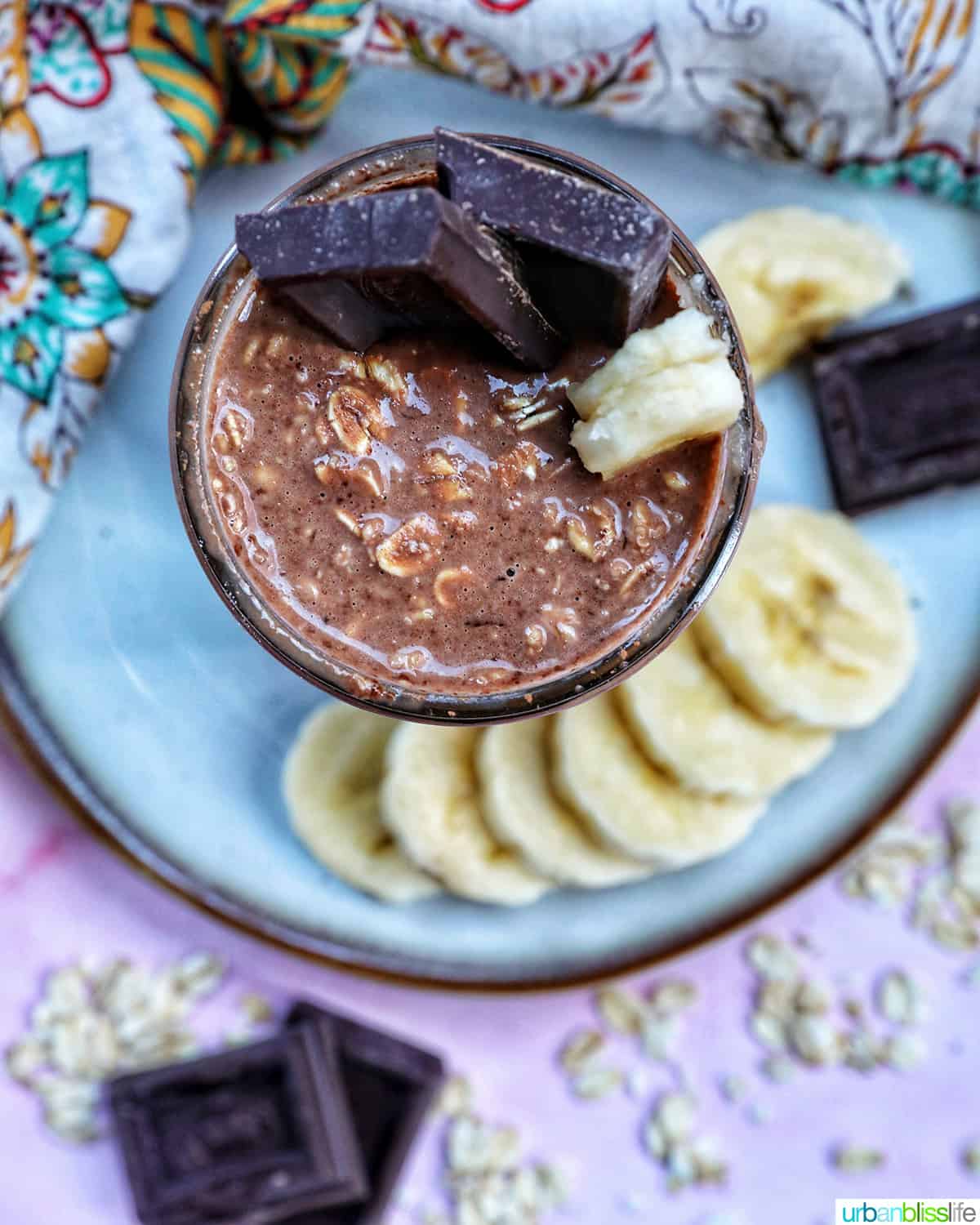 chocolate protein overnight oats topped with banana slices and chocolate pieces.