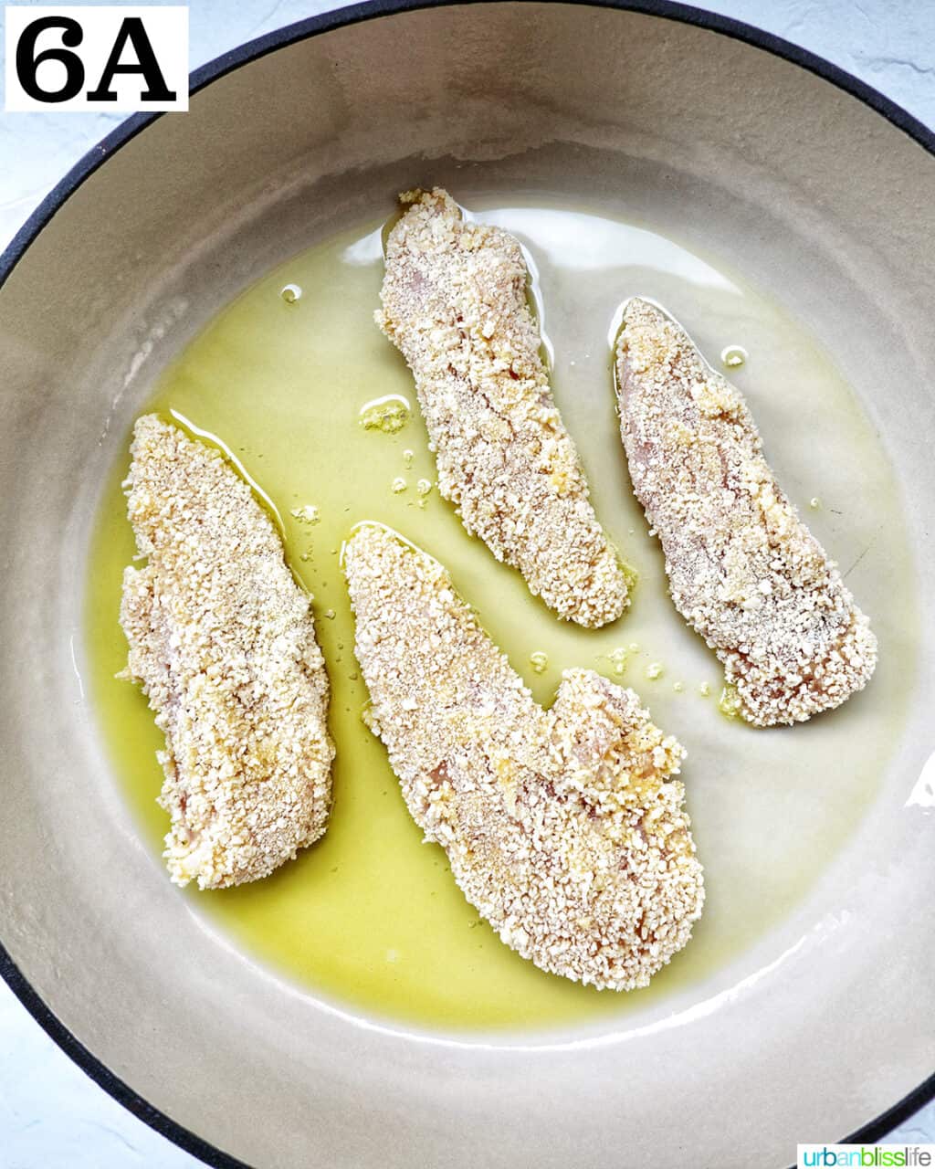 breaded chicken tenders in a large skillet with olive oil.