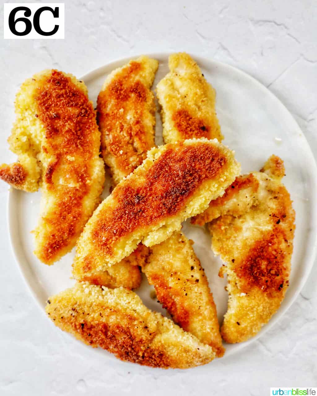 plate full of breaded cooked chicken tenders.