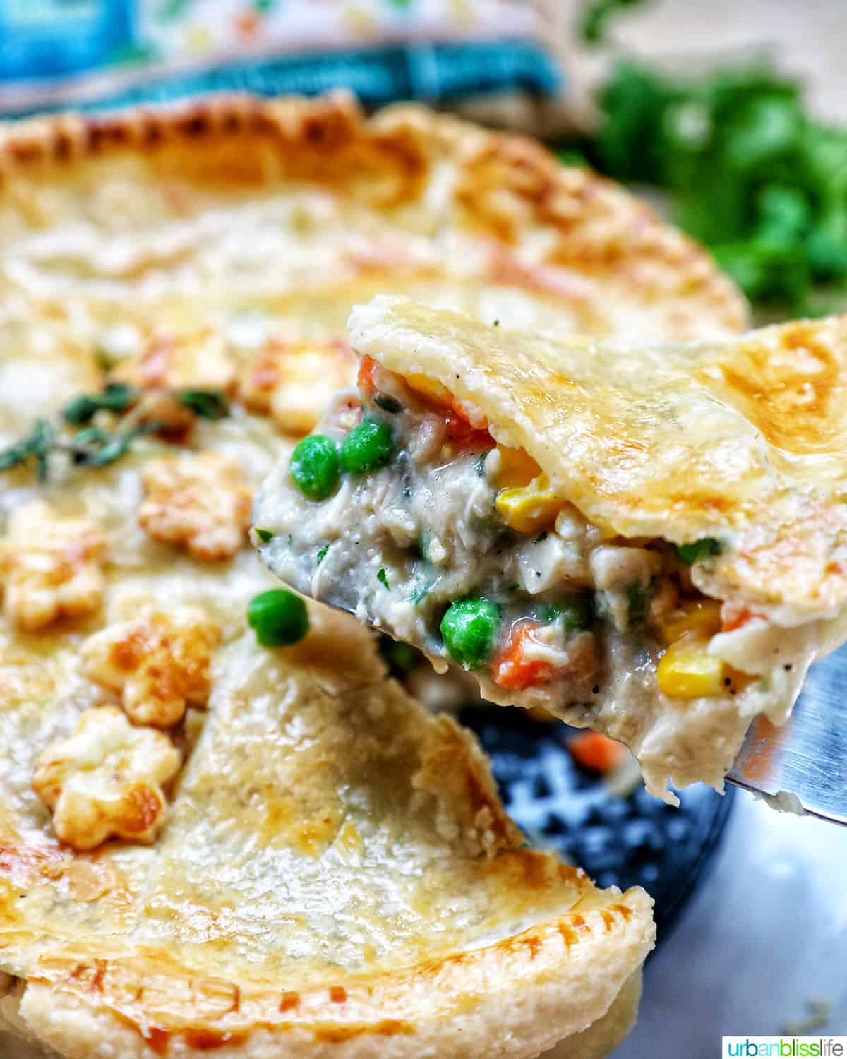 slice of chicken pot pie being lifted away from the rest of the chicken pot pie.