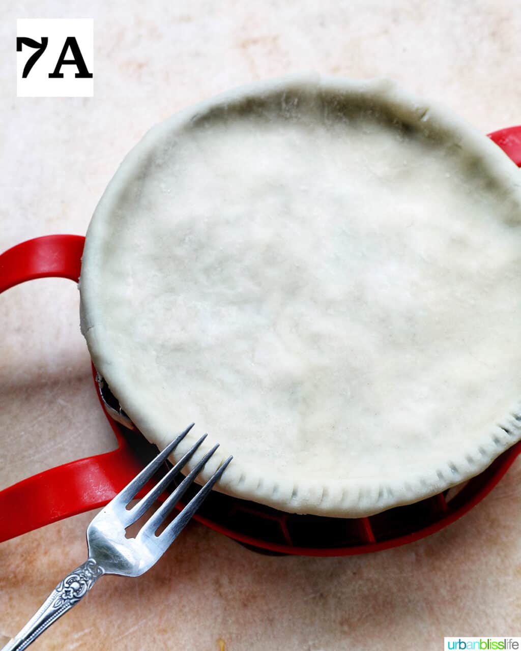 fork pressing on the sides of unbaked top crust.