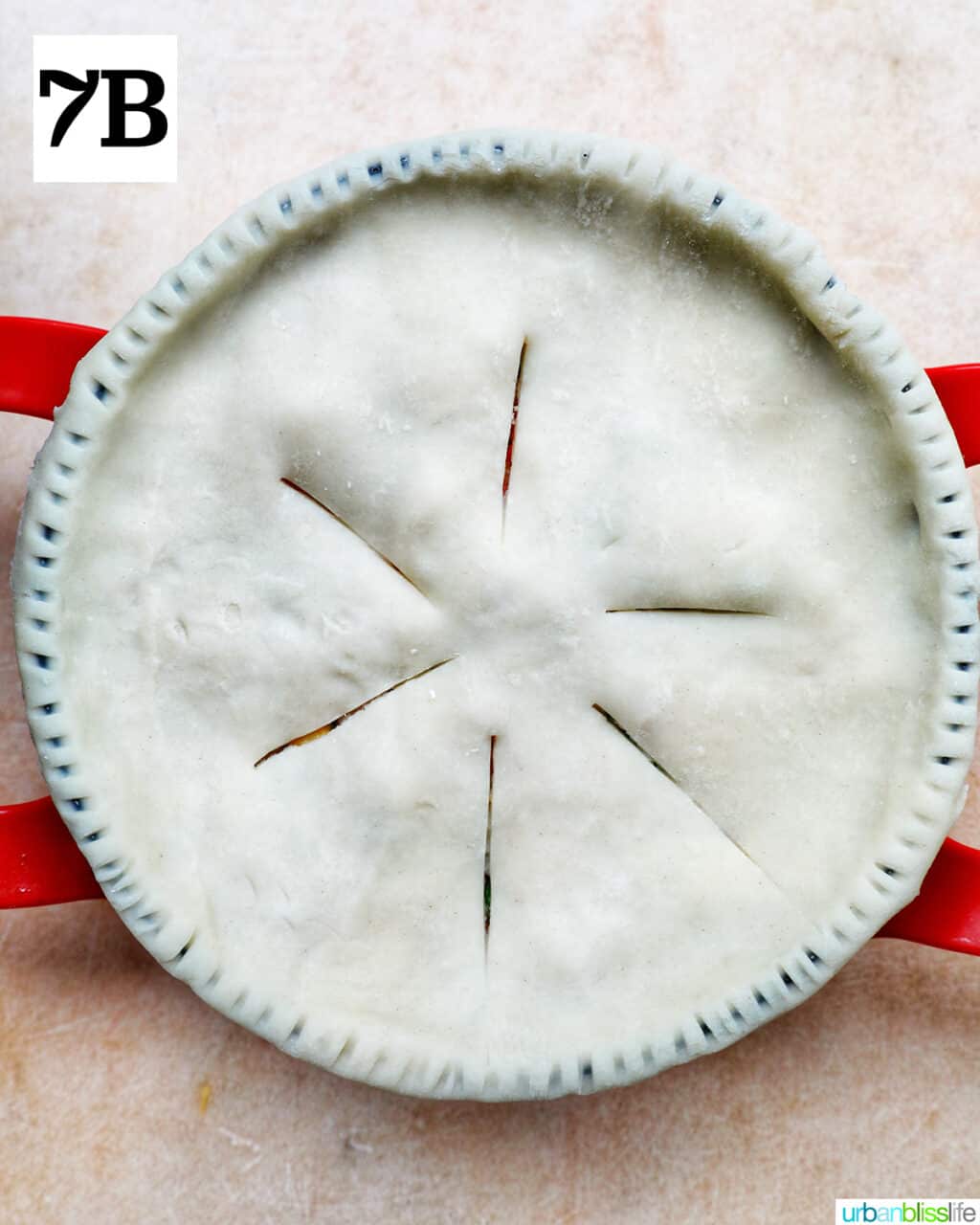 unbaked top pie crust with slits cut at the top in a baking pan.