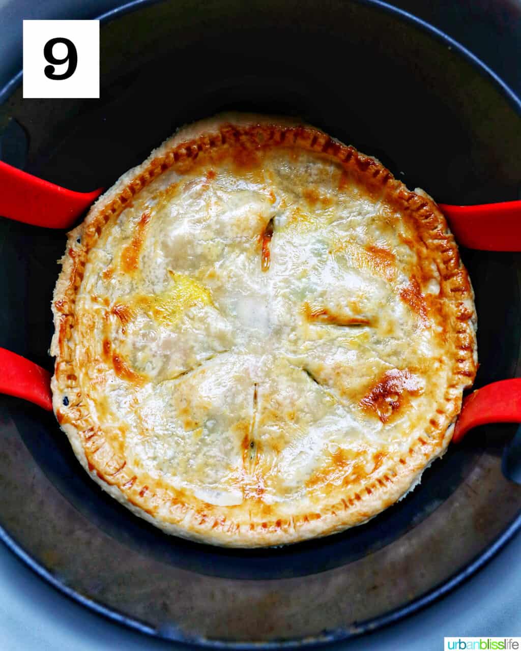 baked chicken pot pie with flaky crust in an air fryer basket.