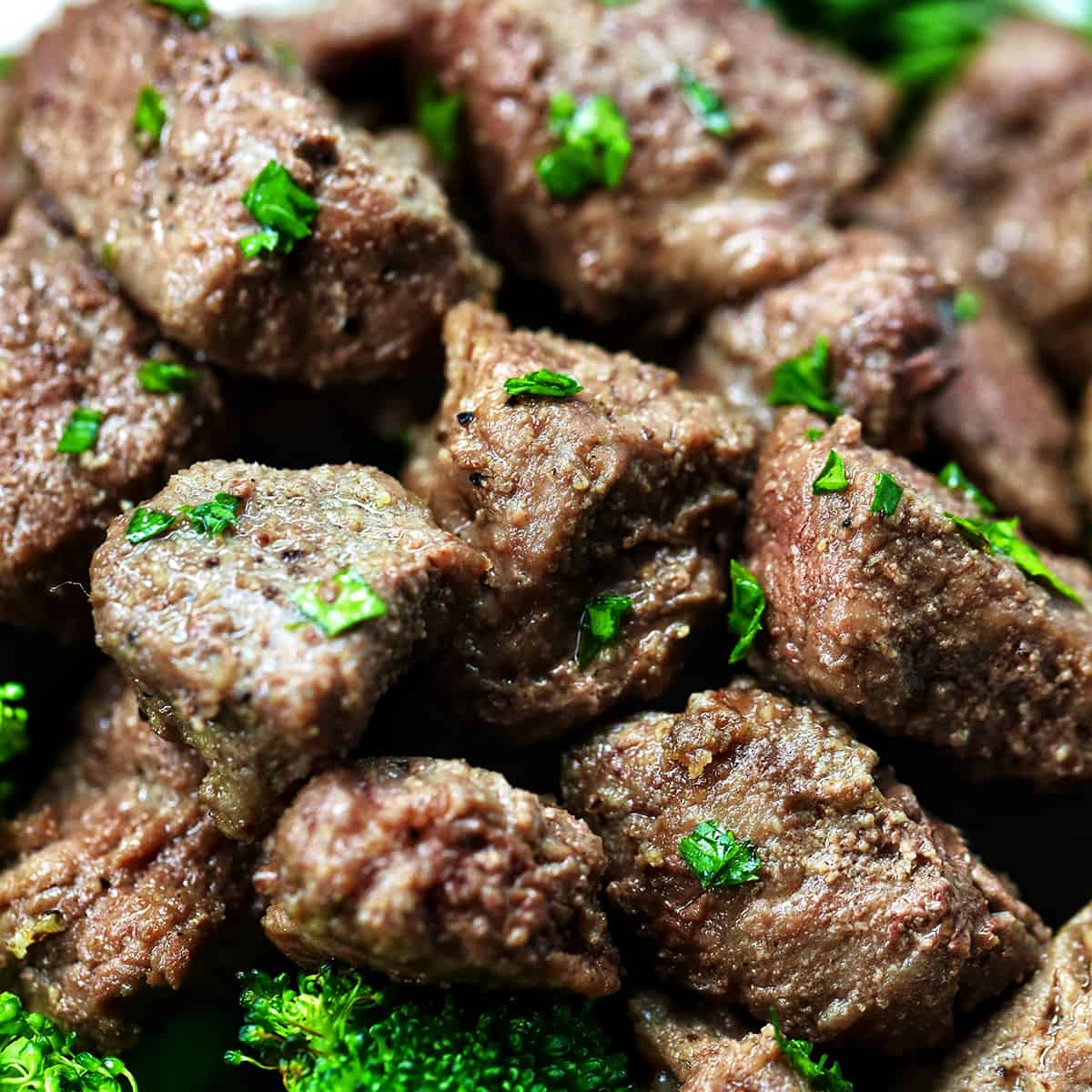air fryer steak bites with chopped parsley garnish.
