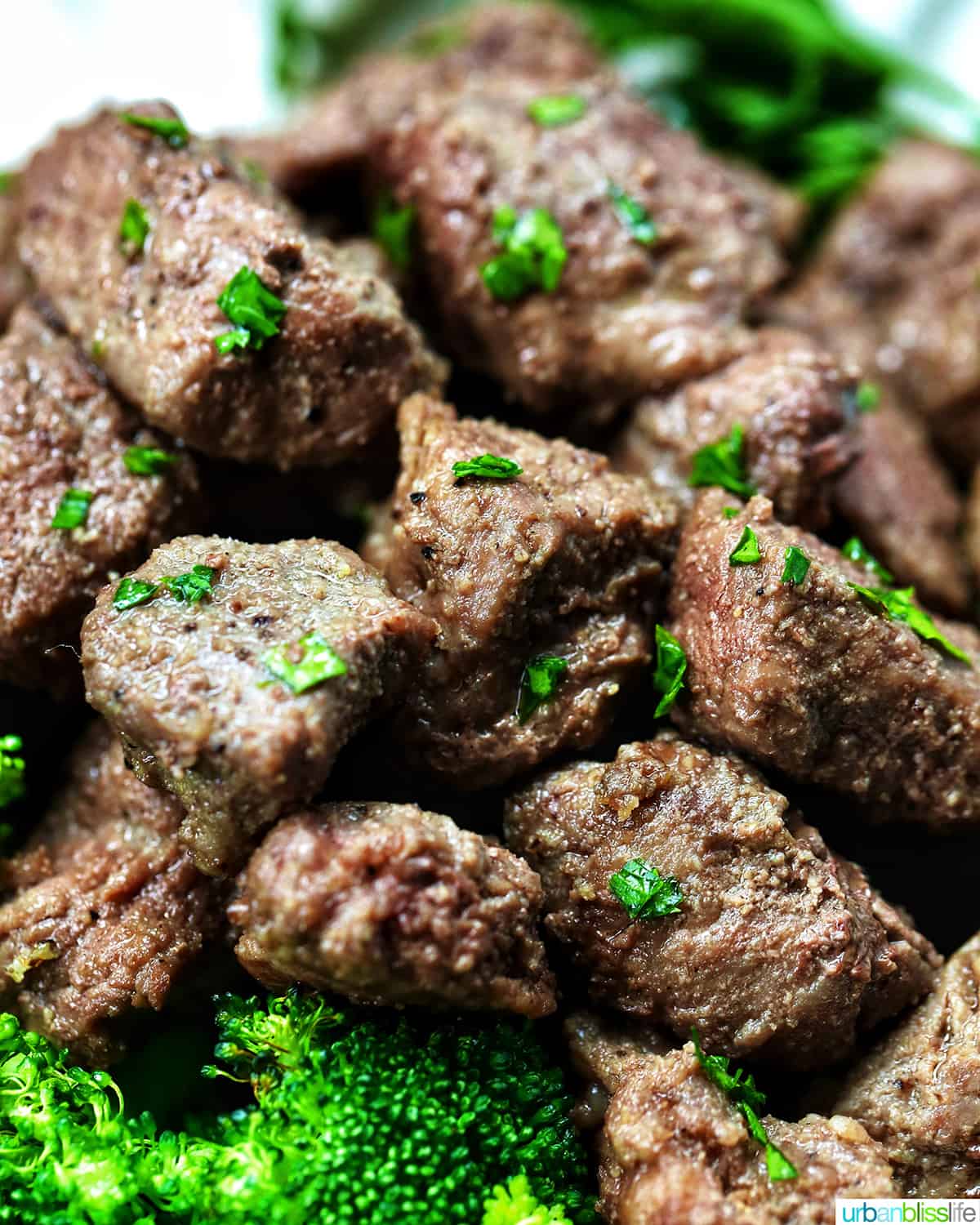air fryer steak bites with chopped parsley garnish.