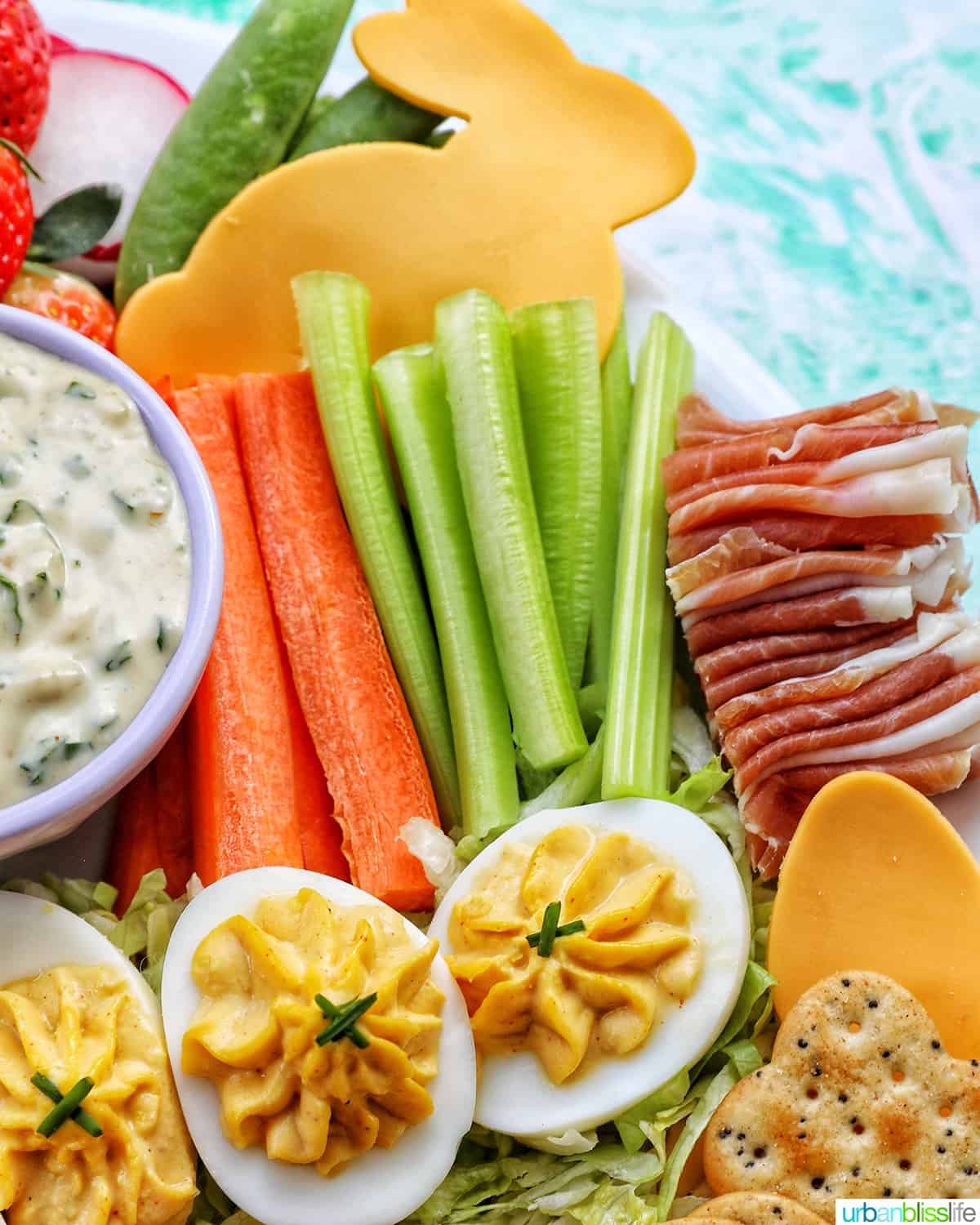 sliced carrots, celery, cheese slices cut out in fun Easter shapes, sliced prosciutto.