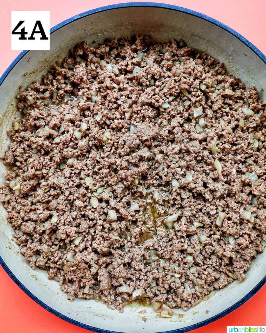 cooked ground beef in a large white pan.