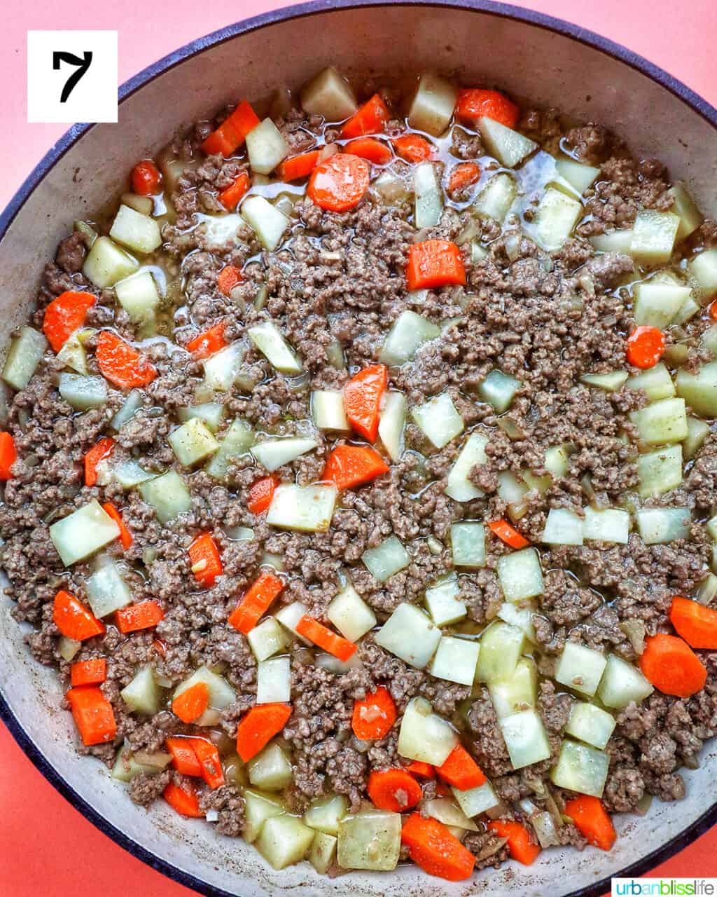 Filipino beef giniling cooking in a large white pan.