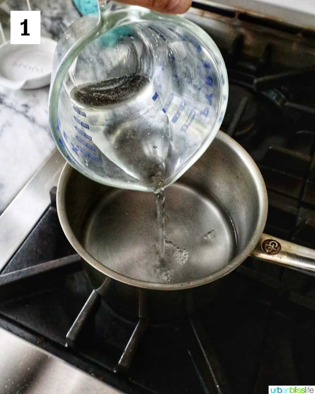 pouring water into a saucepan.