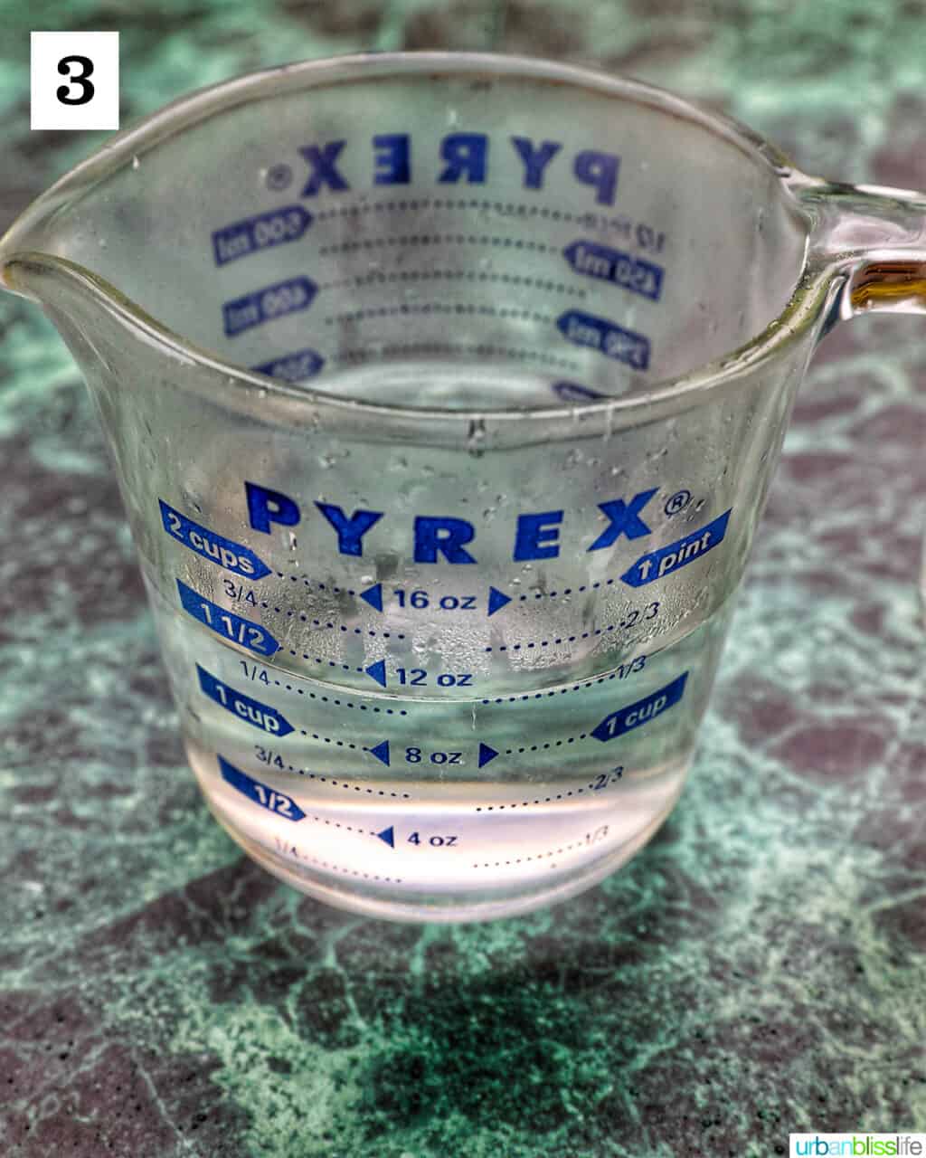 measuring cup with vodka in it.