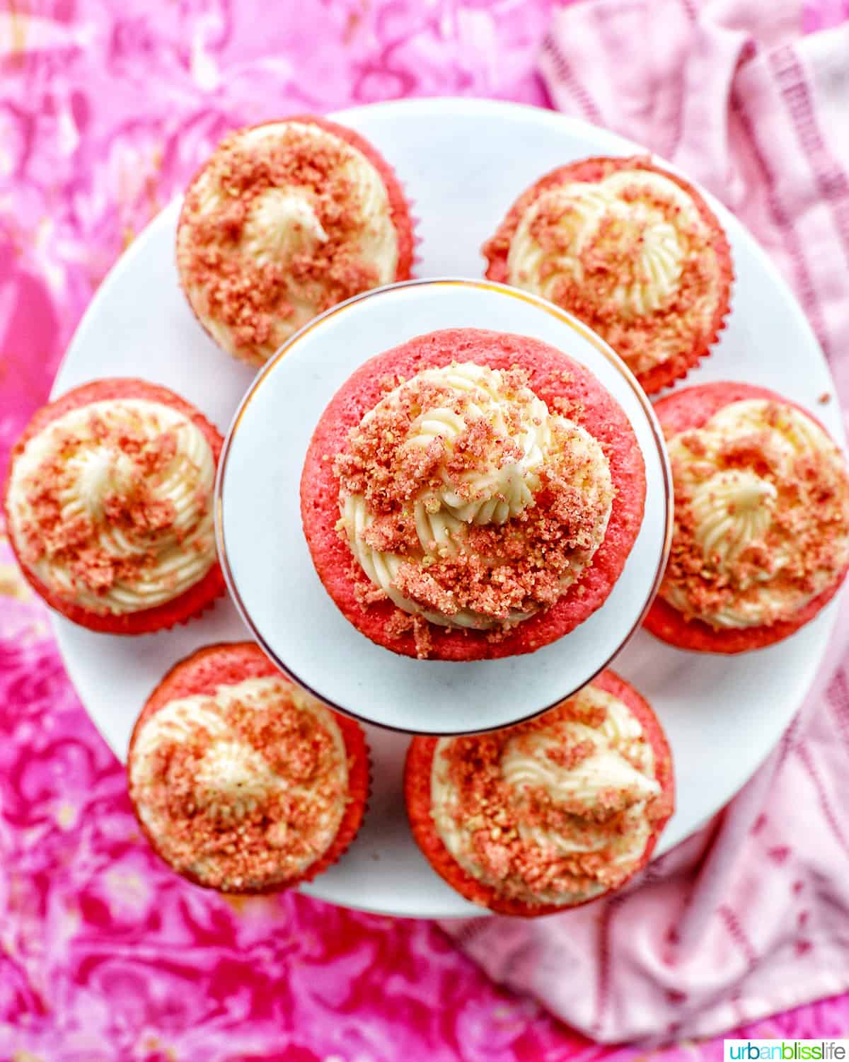 several strawberry crunch cupcakes on stacked cupcake pedestals.