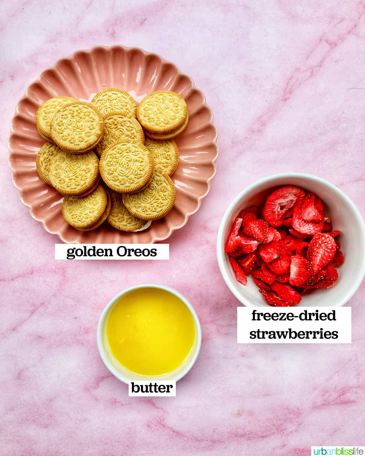 bowls of freeze dried strawberries, melted butter, and golden oreos.