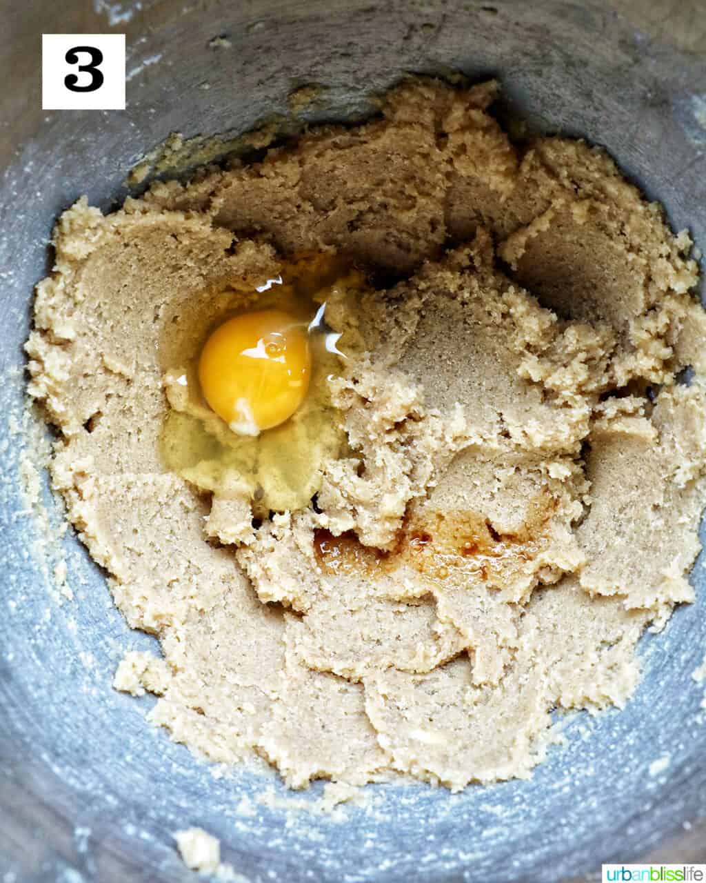 cookie batter with an egg in a stand mixer bowl.