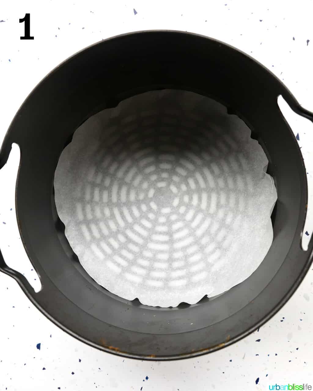 air fryer basket lined with parchment paper.