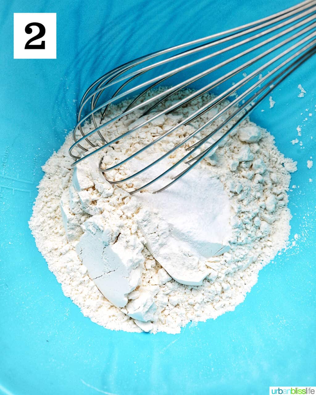 whisk in dry ingredients in a blue bowl.