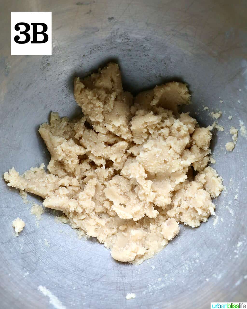 cookie dough batter in a stainless steel bowl.