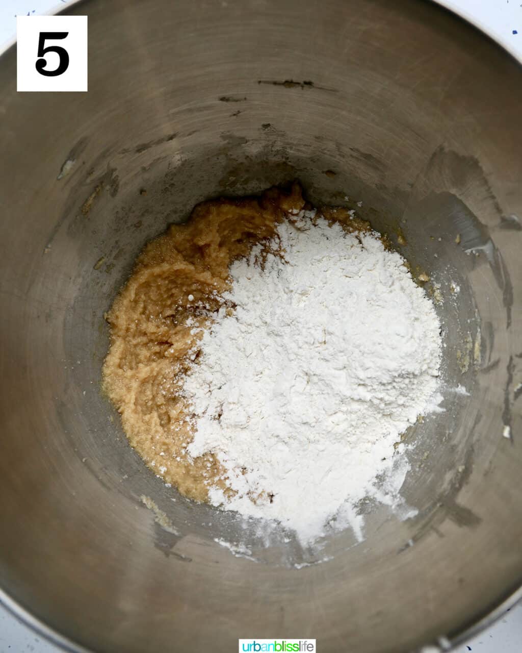 dry ingredients added to wet ingredients in a stand mixer bowl.