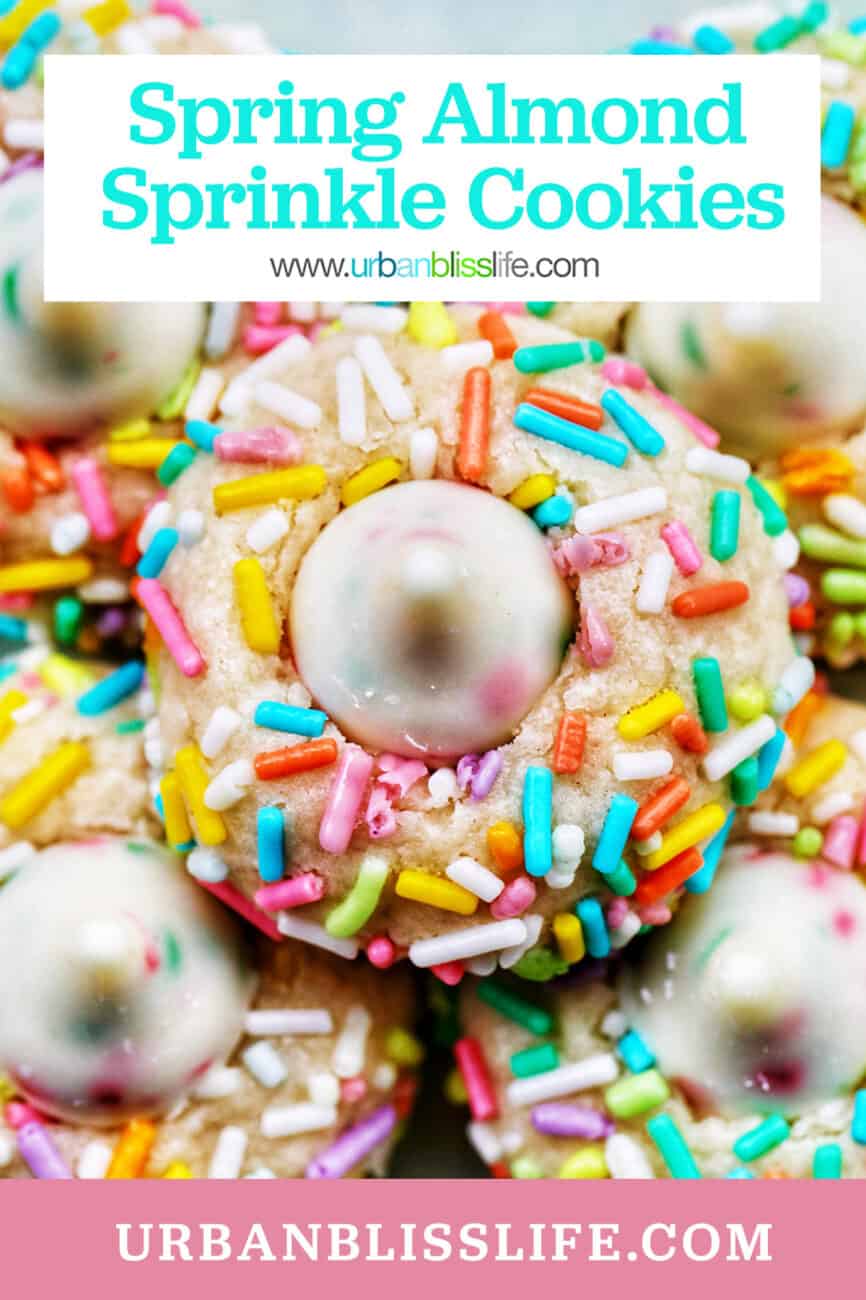 several spring almond sprinkle cookies stacked on top of one another.