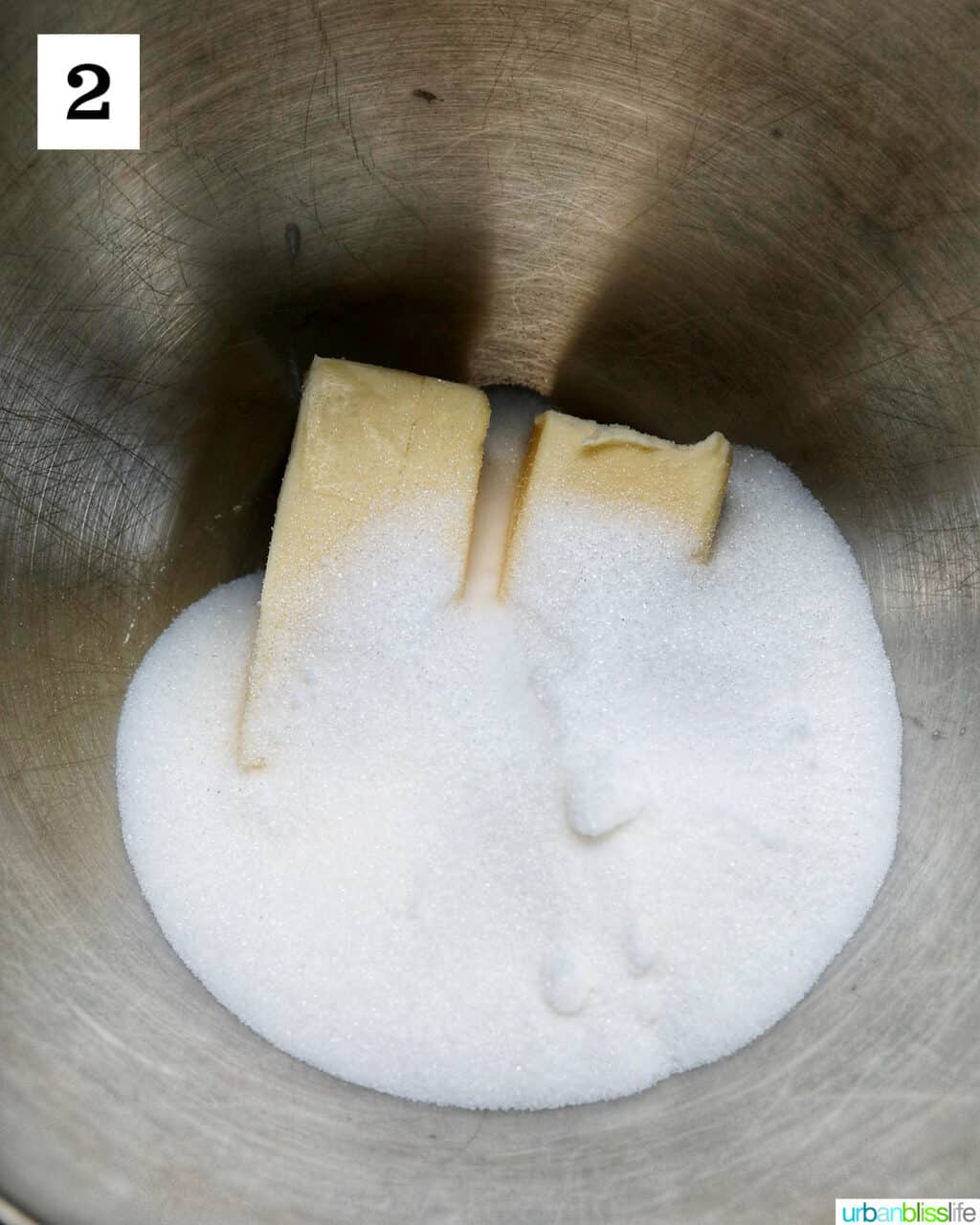 butter and white sugar in a stainless steel bowl.