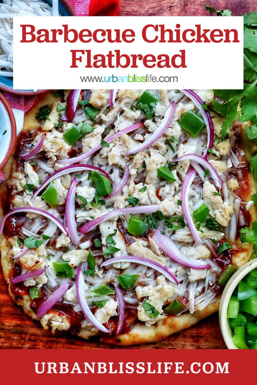 barbecue chicken flatbread pizza on a wooden board with sides of cheese and chopped cilantro for garnish.