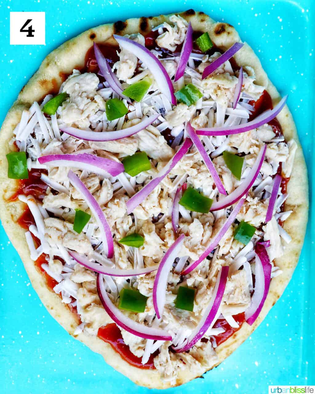 red onions, green peppers, chicken breast and shredded cheese over barbecue sauce on flatbread.