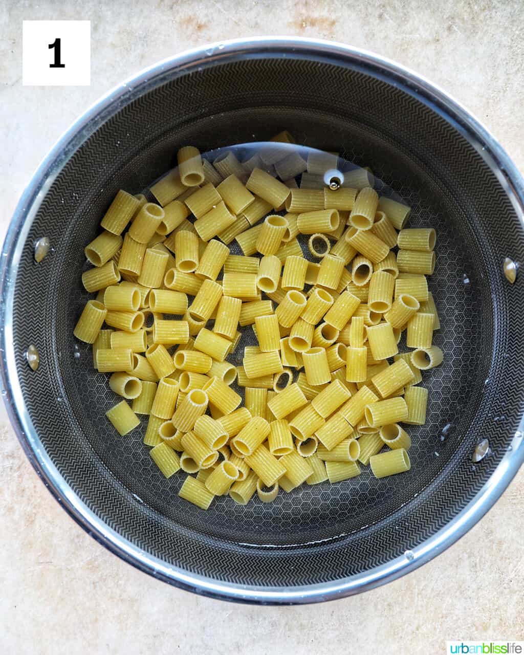 rigatoni pasta in a pot of water.