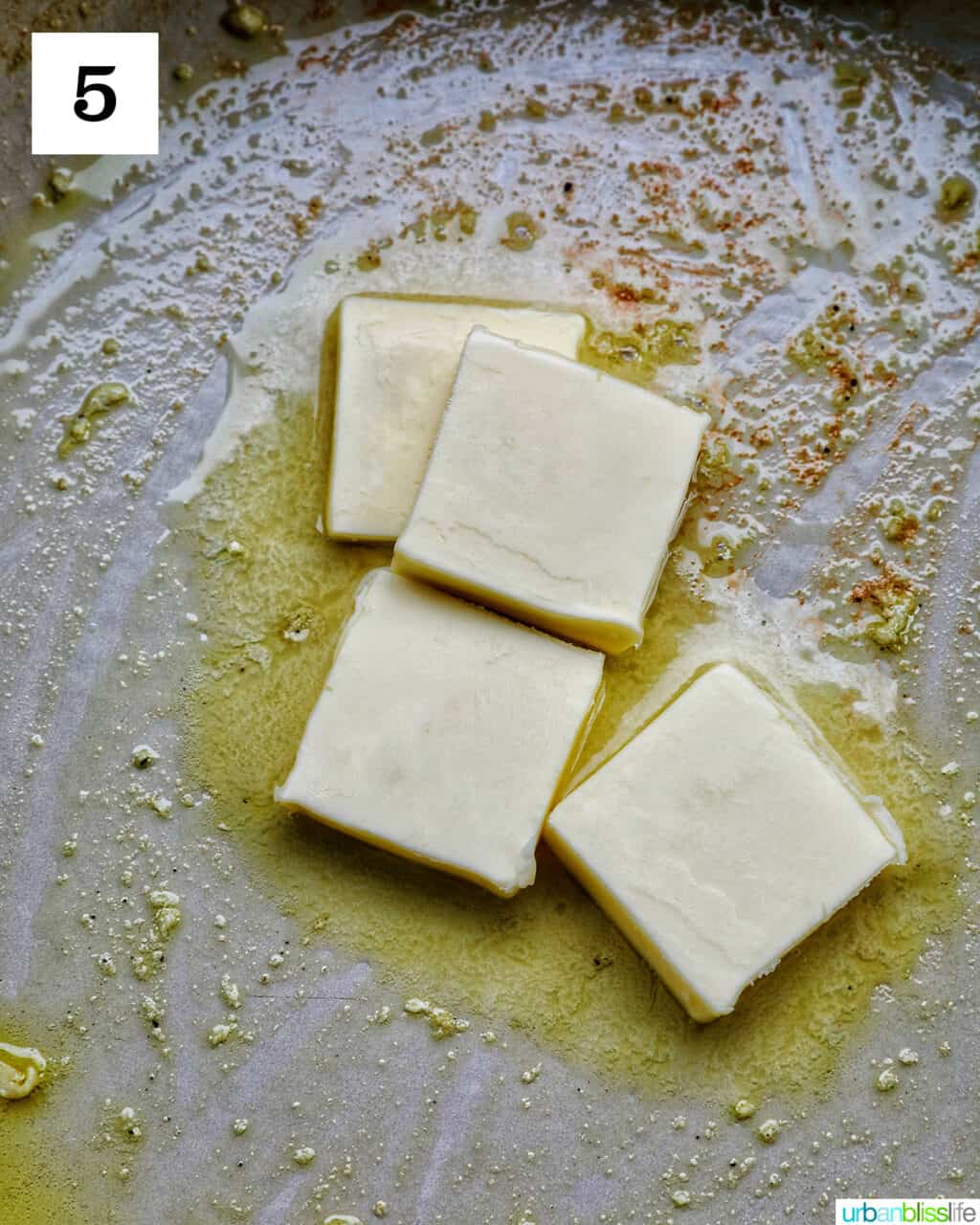 pats of butter melting in a large skillet.