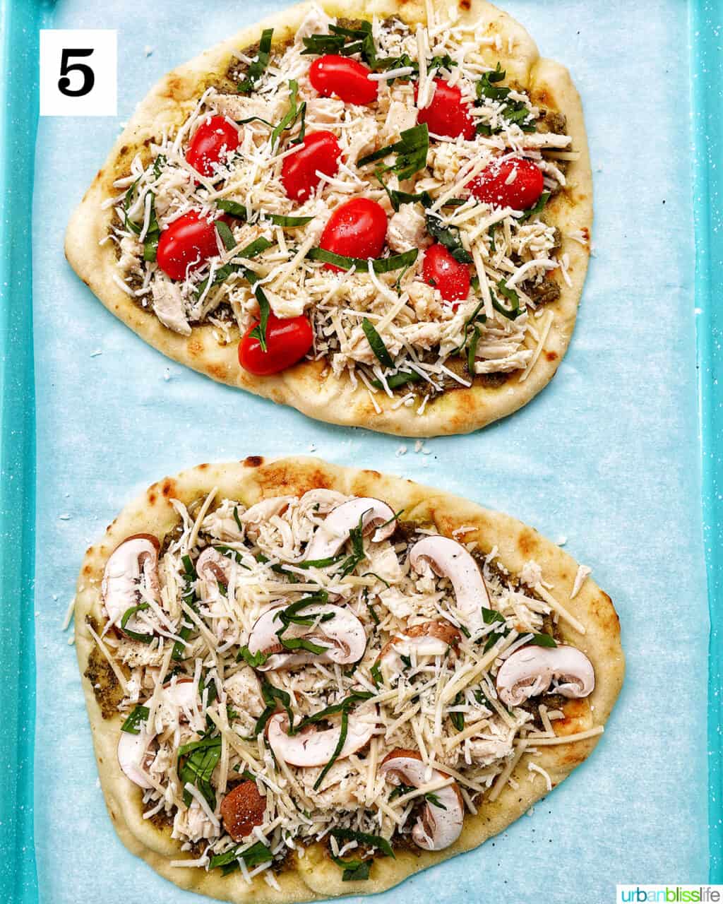 two chicken pesto flatbreads, one with tomatoes and one with mushrooms.