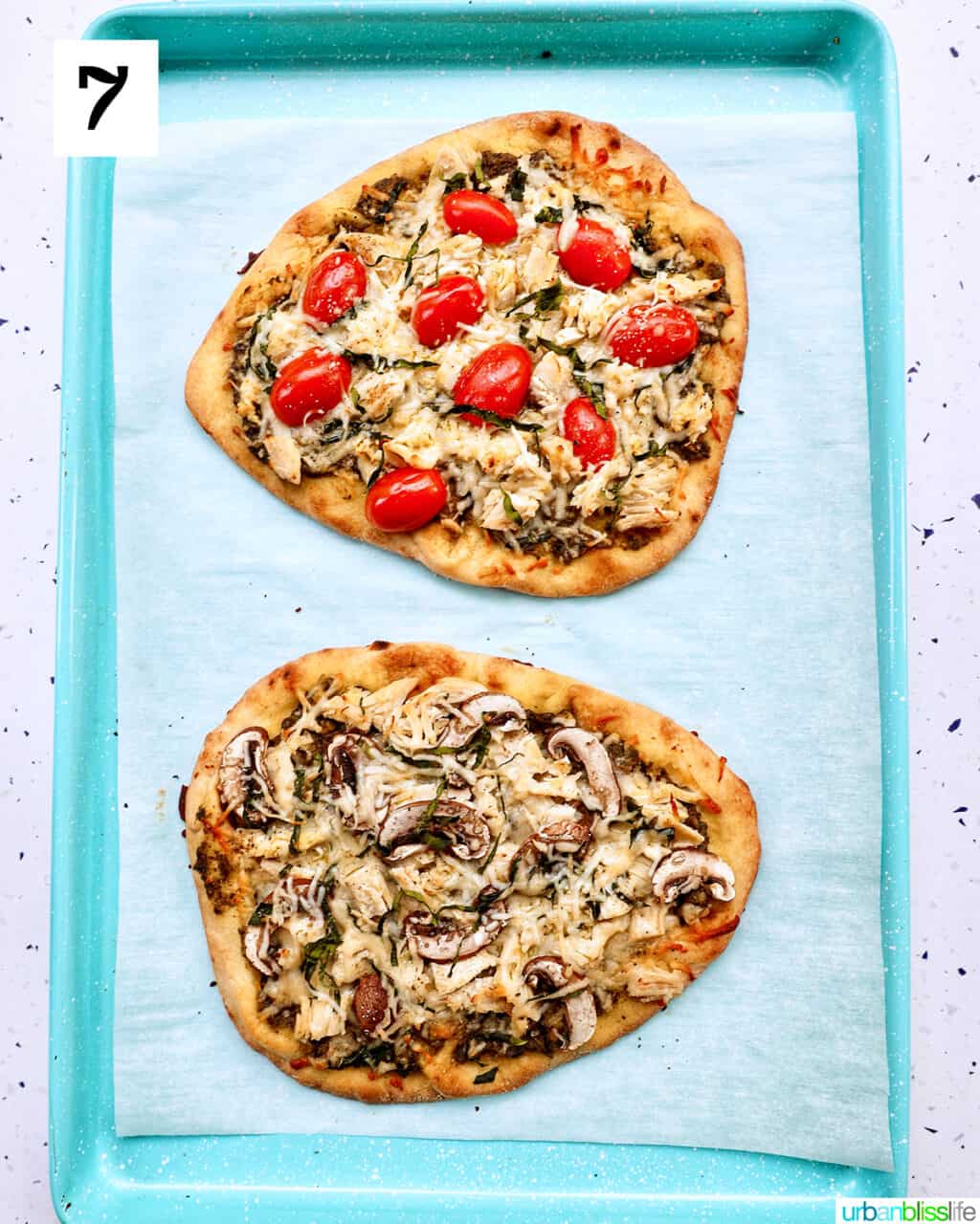 two chicken pesto flatbreads, one with tomatoes and one with mushrooms.