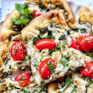 slices of chicken pesto flatbread on a plate.