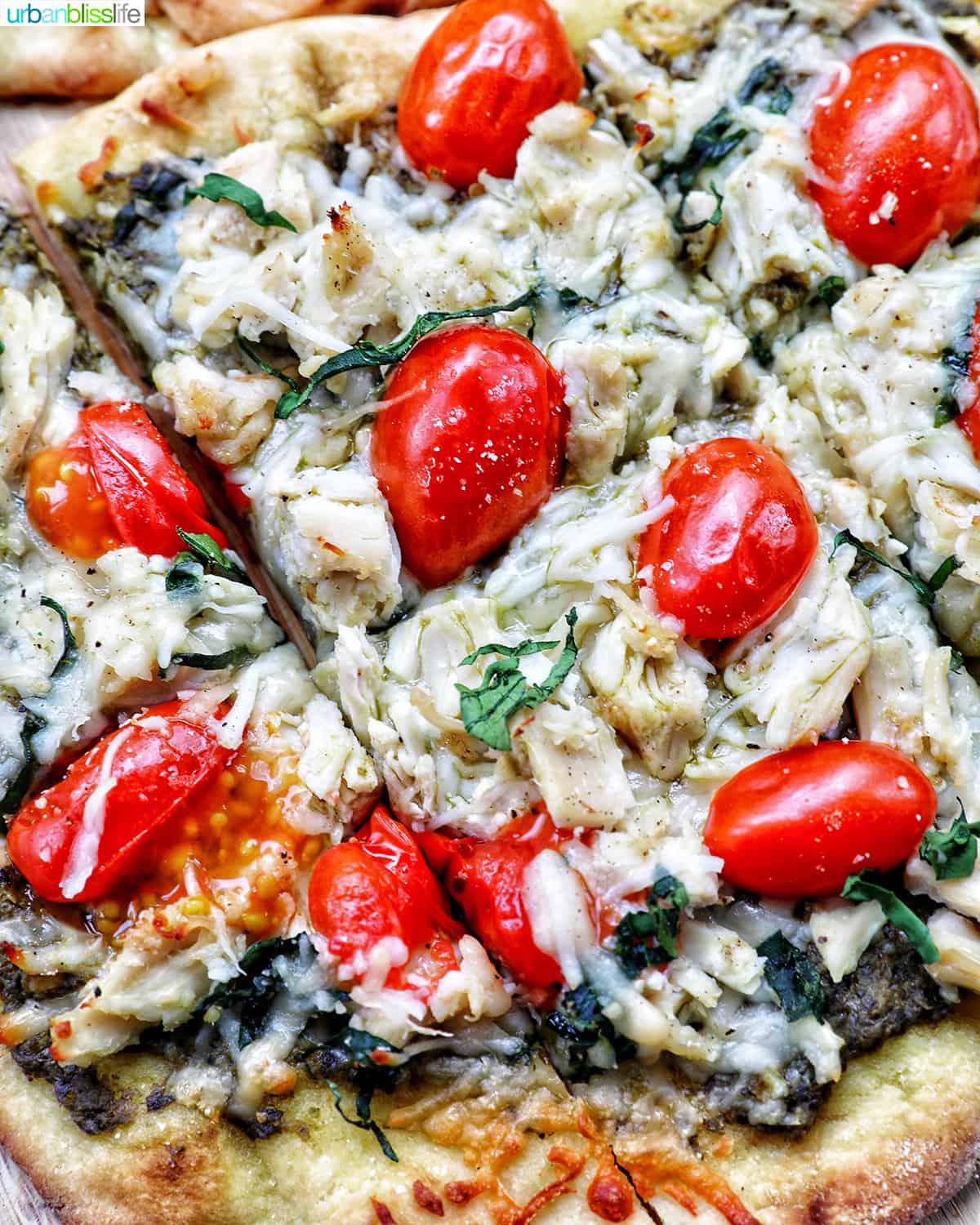 slices of chicken pesto flatbread on a plate.