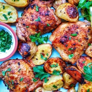 chicken and potatoes garnished with parsley.