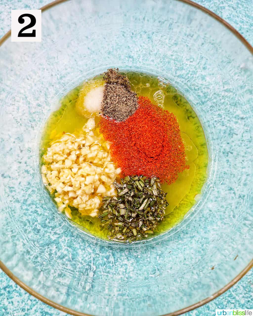bowl of seasonings, oil, and garlic.