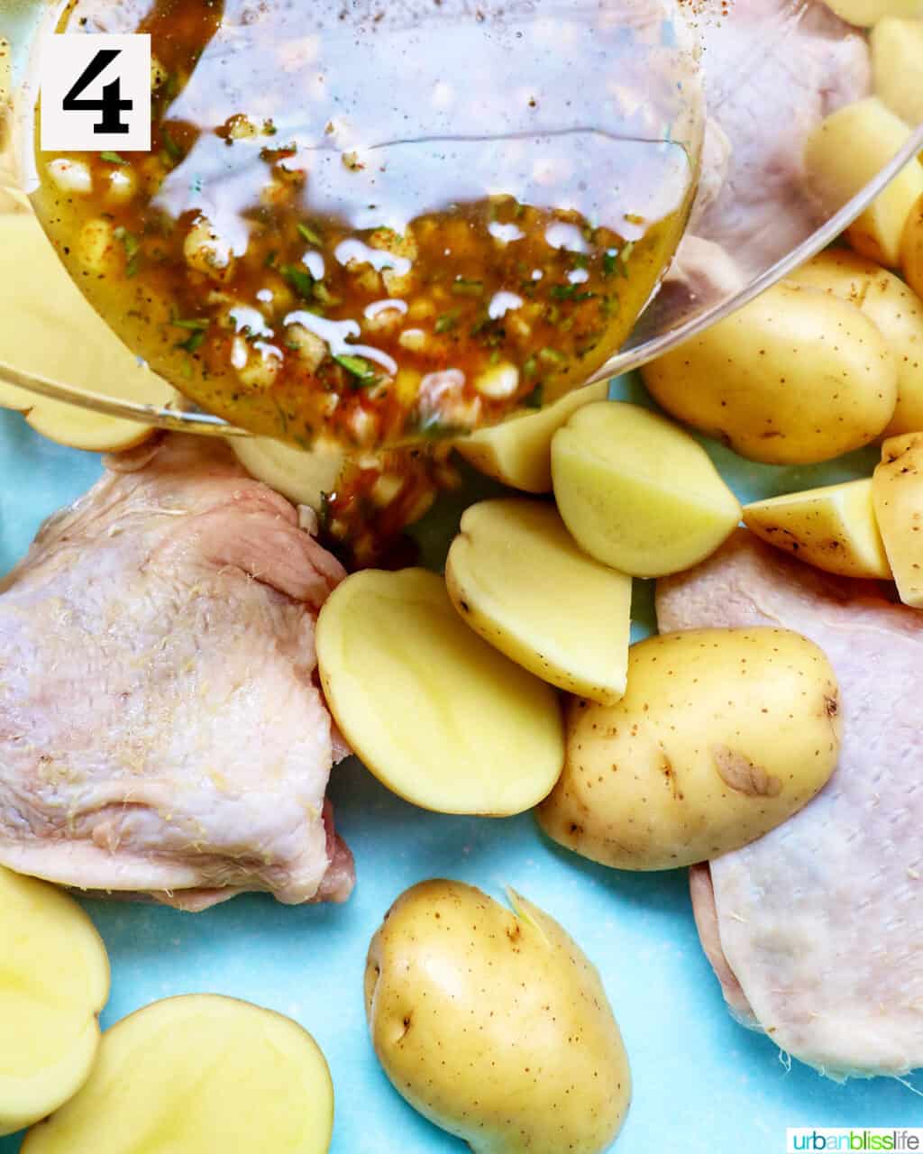 seasoning pouring over raw chicken and potatoes.