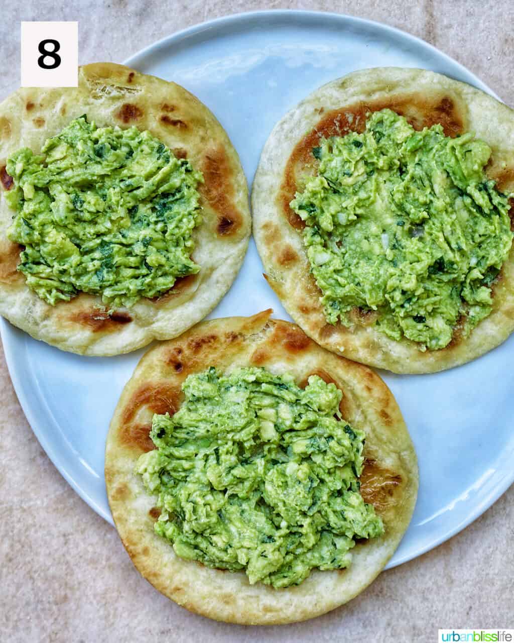 three tortillas topped with guacamole.