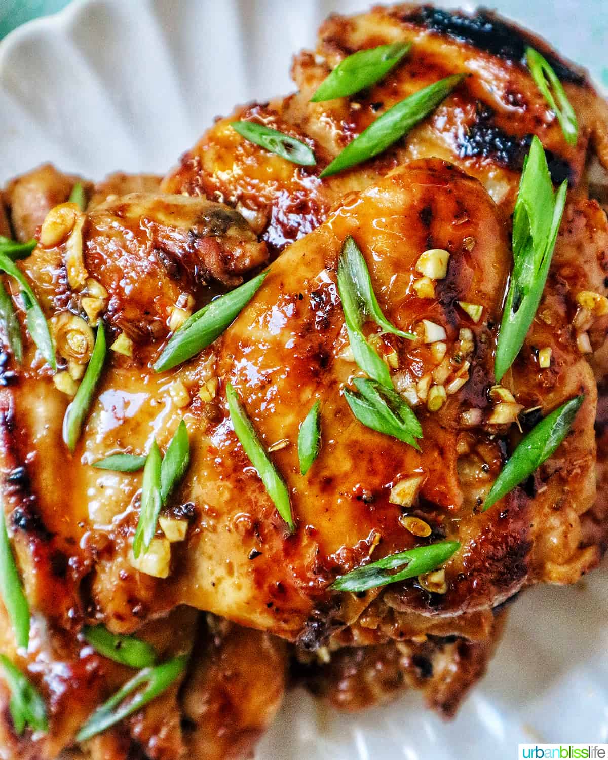 Plate with a stack of Thai Lemongrass Chicken and sliced green onion garnish.