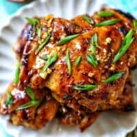 Plate with a stack of Thai Lemongrass Chicken and sliced green onion garnish.
