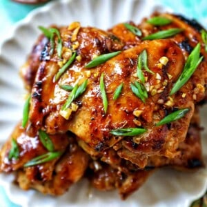 Plate with a stack of Thai Lemongrass Chicken and sliced green onion garnish.