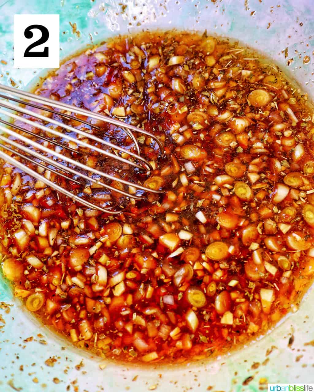 bowl with a whisk and Asian sauce ingredients.