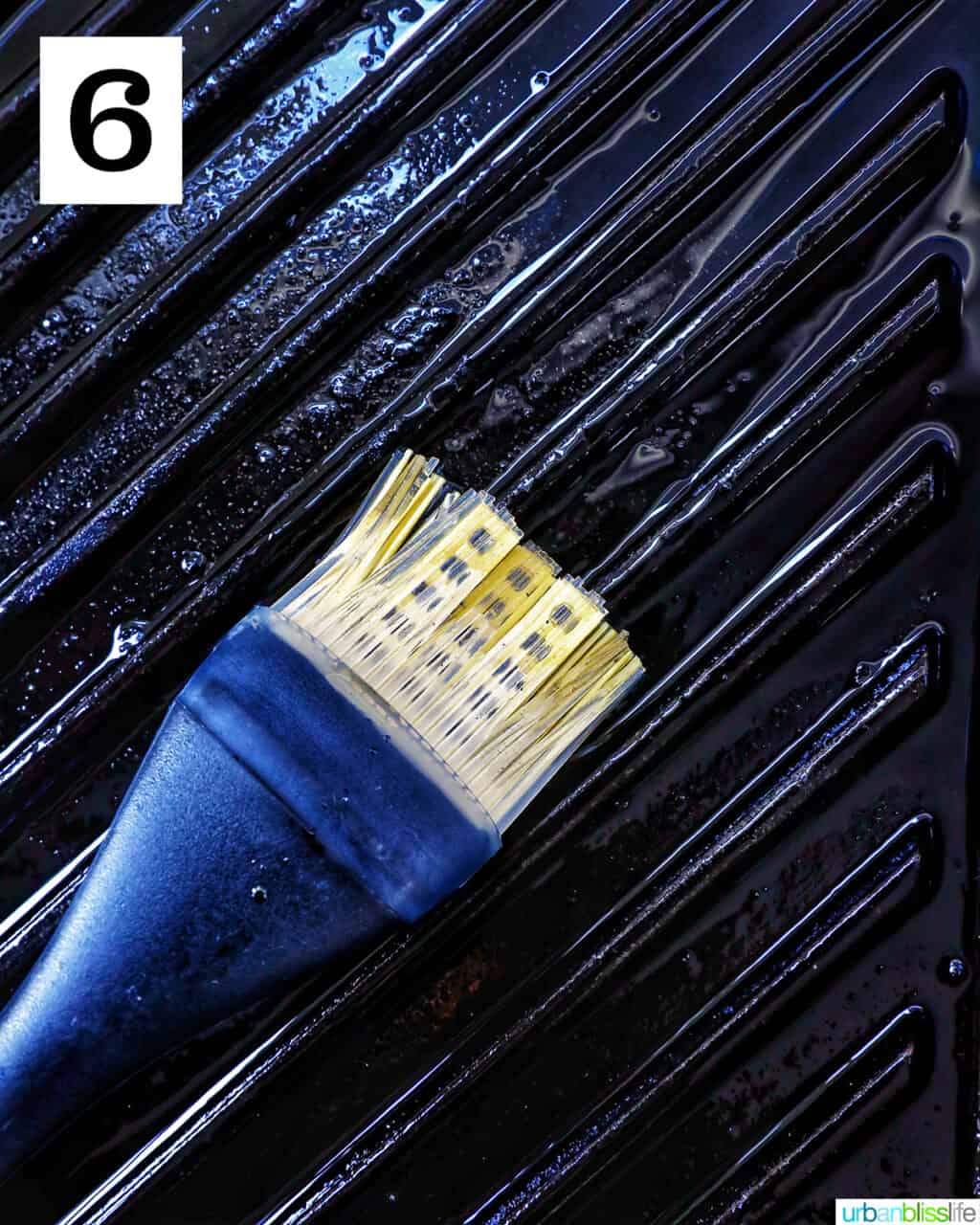 pastry brush brushing oil on a grill pan.