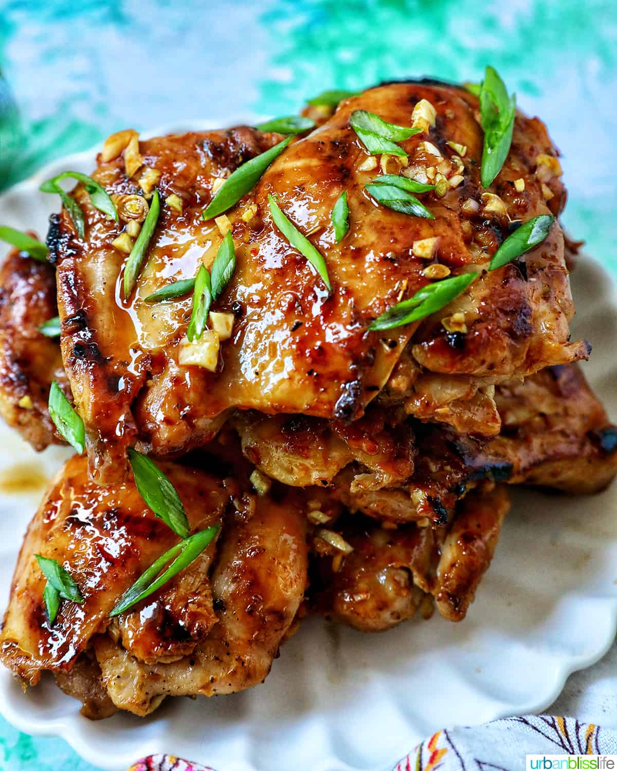 Plate with a stack of Thai Lemongrass Chicken and sliced green onion garnish.