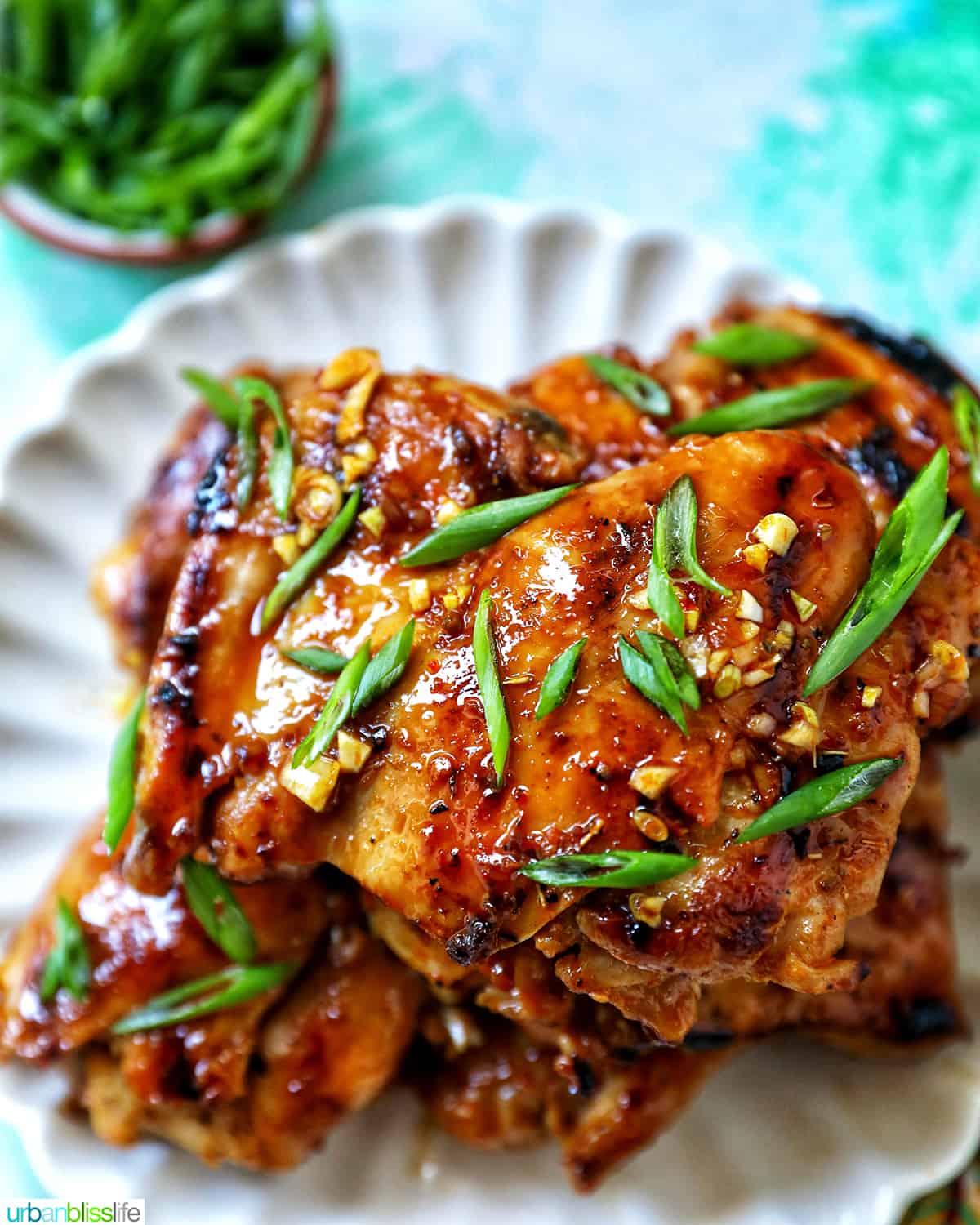 Plate with a stack of Thai Lemongrass Chicken and sliced green onion garnish.