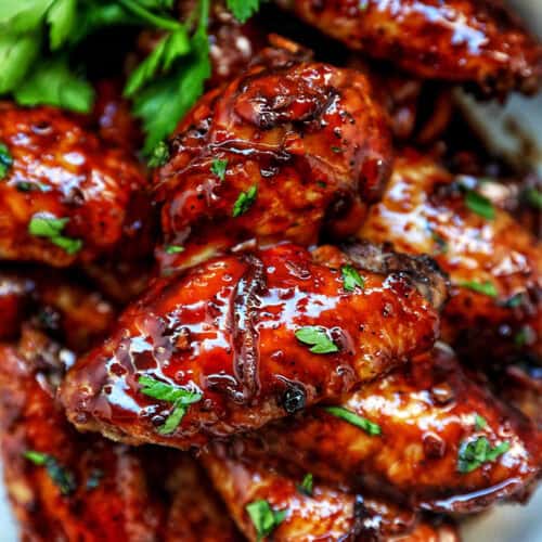 bowl of Filipino adobo chicken wings and fresh parsley.