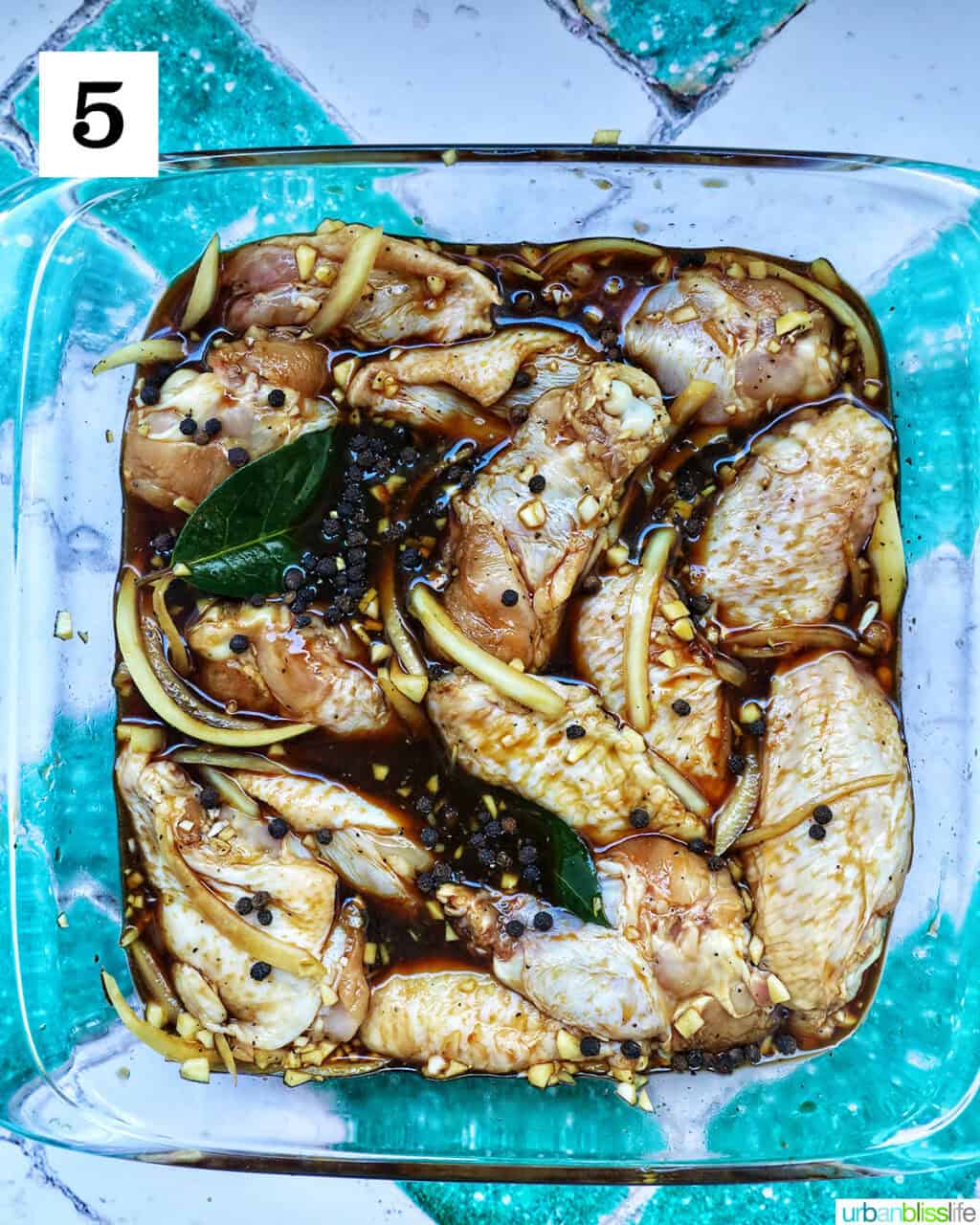 chicken marinating in adobo sauce.