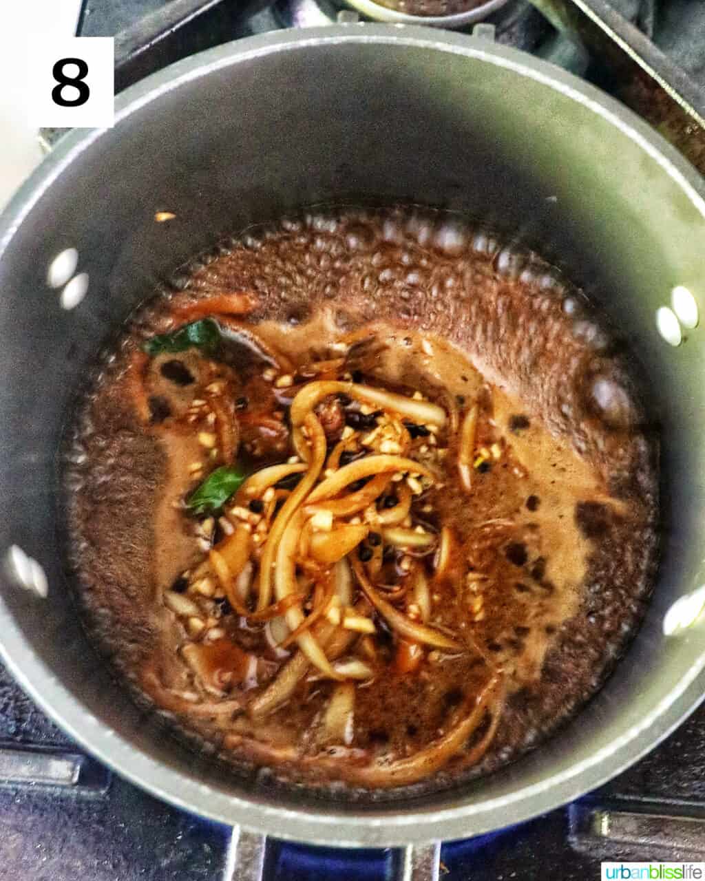 cooking adobo marinade in a saucepan.