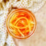mason jar with Filipino atchara condiment - papaya, carrots, red bell pepper, garlic, ginger.