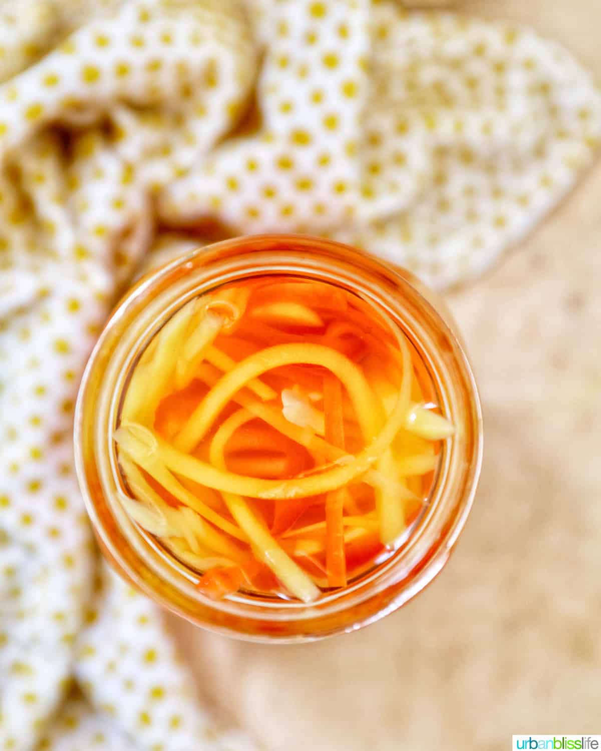 mason jar with Filipino atchara condiment - papaya, carrots, red bell pepper, garlic, ginger.