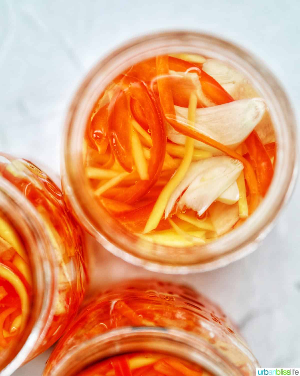 mason jar with Filipino atchara condiment - papaya, carrots, red bell pepper, garlic, ginger.